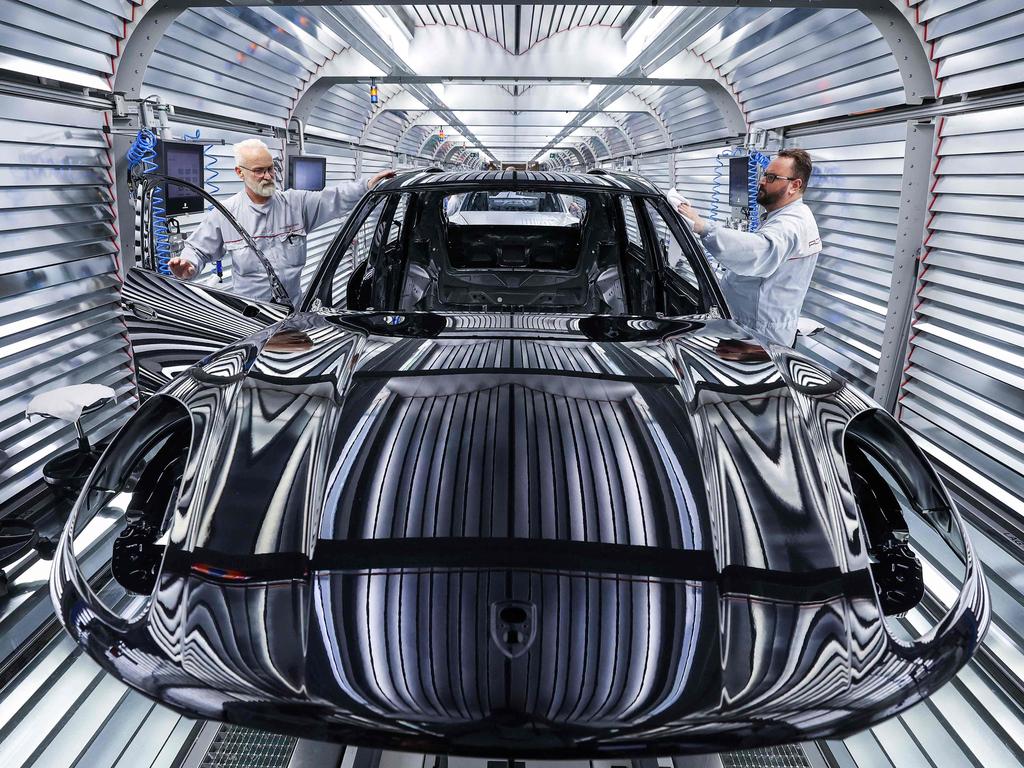Workers assemble a Porsche Macan model on the production and quality control line in Germany. Picture: Ronny Hartmann/AFP