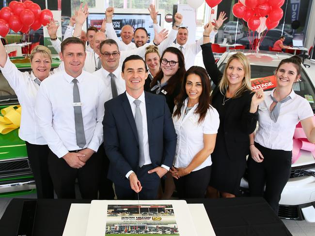 Josh Hilton, principal (centre), cuts the cake with staff members during the Brian Hilton Toyota 50th anniversary celebrations. Picture: Peter Clark