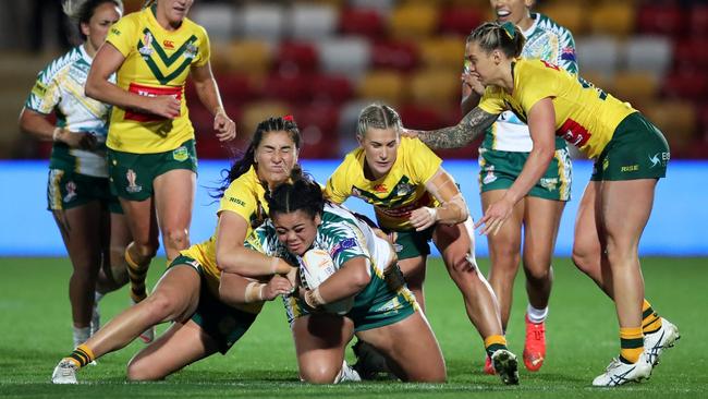 April Ngatupuna of Cook Islands is tackled by Olivia Kernick and Shenae Ciesiolka of Australia during the Women's Rugby League World Cup. (Photo by Jan Kruger/Getty Images for RLWC)