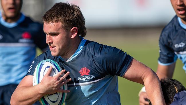 Waratah Academy player Louis Dalrymple on the run. Tavita Loga