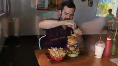 Cairns Post's Rowan Sparkes tackles the Big Boy Burger at Apex as part of a Decadent Food of FNQ for Cairns Eye. VIDEO: STEWART MCLEAN