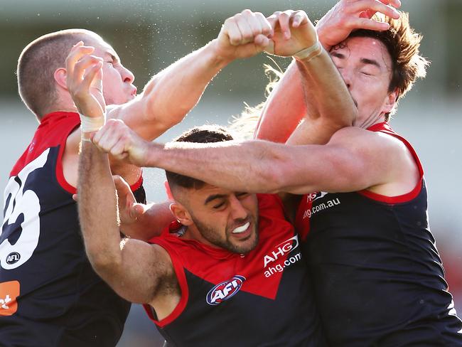 CANBERRA, AUSTRALIA - AUGUST 05:  (EDITORS NOTE: Retransmission with alternate crop.) Christian Salem of the Demons (C) competes for the ball with Tom McDonald (L) and Michael Hibberd (R) of the Demons  during the round 20 AFL match between the Greater Western Sydney Giants and the Melbourne Demons at UNSW Canberra Oval on August 5, 2017 in Canberra, Australia.  (Photo by Matt King/Getty Images)