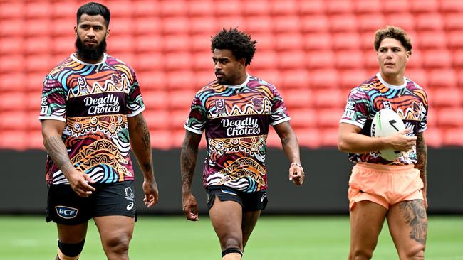 Payne Haas (left), Ezra Mam and Reece Walsh at Broncos training on Monday. (Photo by Bradley Kanaris/Getty Images)