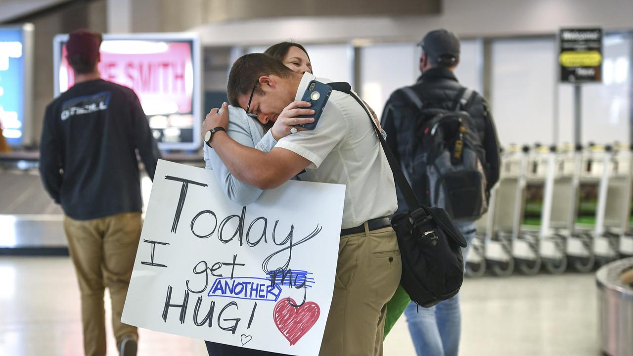 Loved ones will no longer be able to hug or reunite at the airport. Picture: Dan Pelle/AP