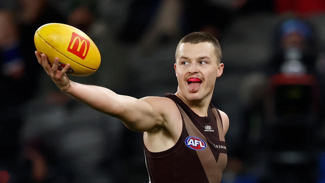MELBOURNE, AUSTRALIA - JUNE 05: Jack Ginnivan of the Hawks shows the ball to Bulldogs players during the 2025 AFL Round 13 match between the Western Bulldogs and the Hawthorn Hawks at Marvel Stadium on June 5, 2025 in Melbourne, Australia. (Photo by Michael Willson/AFL Photos via Getty Images)