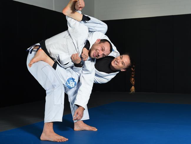 (L-R) Lachlan Giles with his fiance Livia Gluchowska in a bow and arrow choke hold at Absolute Mixed Martial Arts in St Kilda. Brazillian Ju-Jitsu world champions and cute couple are also local physiotherapists. Picture: Josie Hayden