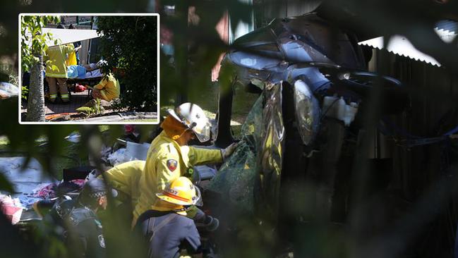 Fire crews work to cut Tara out the wreckage of her car after Lionel Patea chased her through Molendinar. Photo: Scott Fletcher