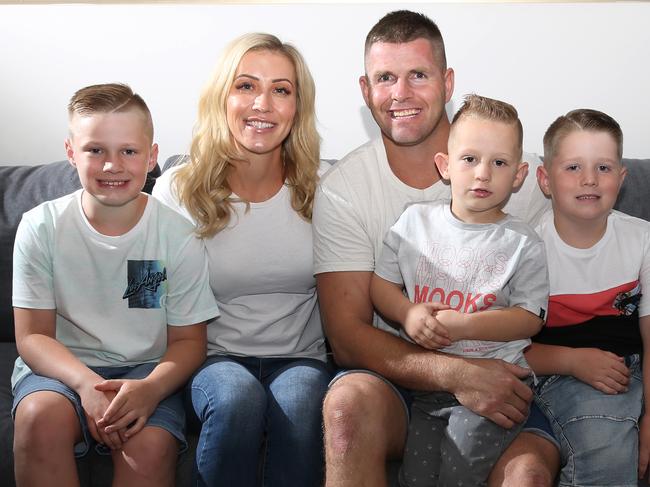 Jason Cloke and his family at their Bundall home. they are Jaon Cloke nd wife Nicole Cloke with Harry 9 (left) Lenny 3 (front) and Duke 6. Picture Glenn Hampson