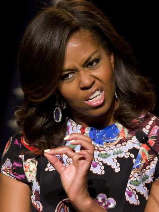 US First Lady Michelle Obama gestures as she gives an address during a visit as part of the US government's 'Let Girls Learn' initiative at Mulberry School for Girls in east London on June 16, 2015. On the first full day of a visit to Britain the US First Lady met with local students in east London and discussed how Britain and the US are working together in order to attempt to expand access to adolescent girls' education around the world. While in London, the First Lady will also host a roundtable meeting on Let Girls Learn, and meet with British Prime Minister Cameron, Samatha Cameron, and Prince Harry. AFP PHOTO / JUSTIN TALLIS