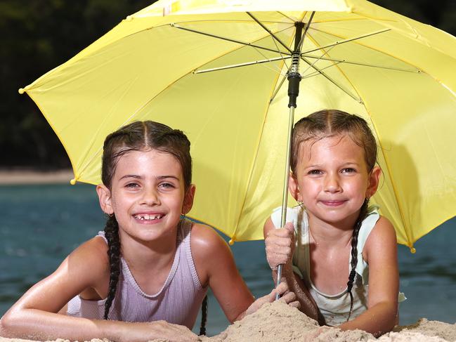 Allegra (7 )  and Evie (5) Bortoni from Reedy Creek preparing for possible rain over the weekend pictured at Tallebudgerra.Photograph : Jason O'BrienMum is Kristen 0413090404 - she is happy to chat about what their plans are if it rains on weekend etc