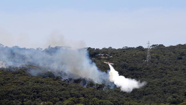 A water-bomber tackles the fire at Happy Valley. Picture: Cathy Davis