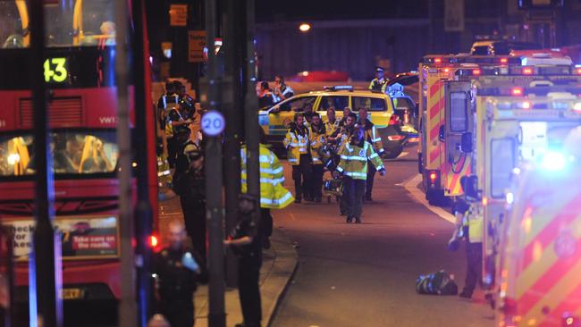 Ambulances line the roads to attend to the injured after pedestrians were mowed down by a van and other stabbed by three men. Picture: AFP