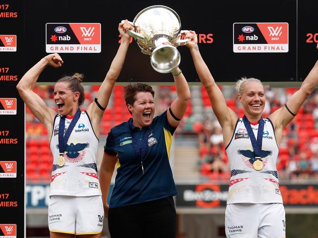 GOLD COAST, AUSTRALIA - MARCH 25: (L-R) Chelsea Randall, Bec Goddard (Coach) and Erin Phillips of the Crows hold the cup aloft after winning the inaugural AFLW Premiership during the 2017 AFLW Grand Final match between the Brisbane Lions and the Adelaide Crows at Metricon Stadium on March 25, 2017 in Gold Coast, Australia. (Photo by Michael Willson/AFL Media/Getty Images)