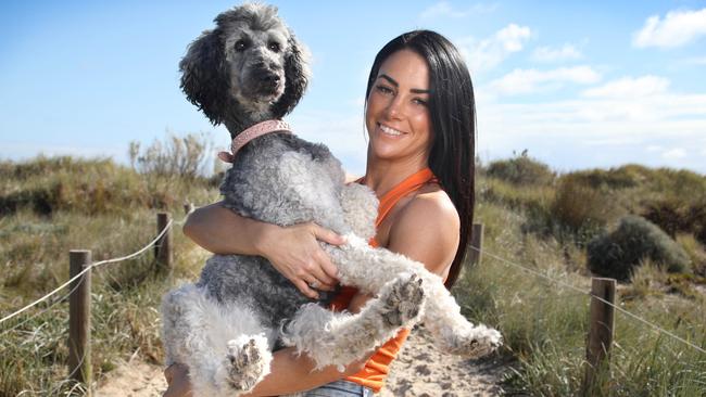 Leah Cummings won the latest season of The Bachelor – which was called The Bachelors — after being proposed to by Thomas, but since the pair have broken up. She is pictured enjoying time at South Brighton Beach with her poodle, Kira. Picture: Dean Martin