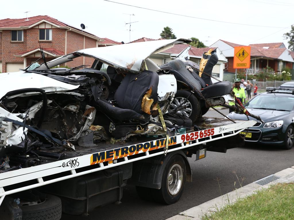 The mangled wreck on the back of a tow truck at the scene of the triple-fatal car crash.