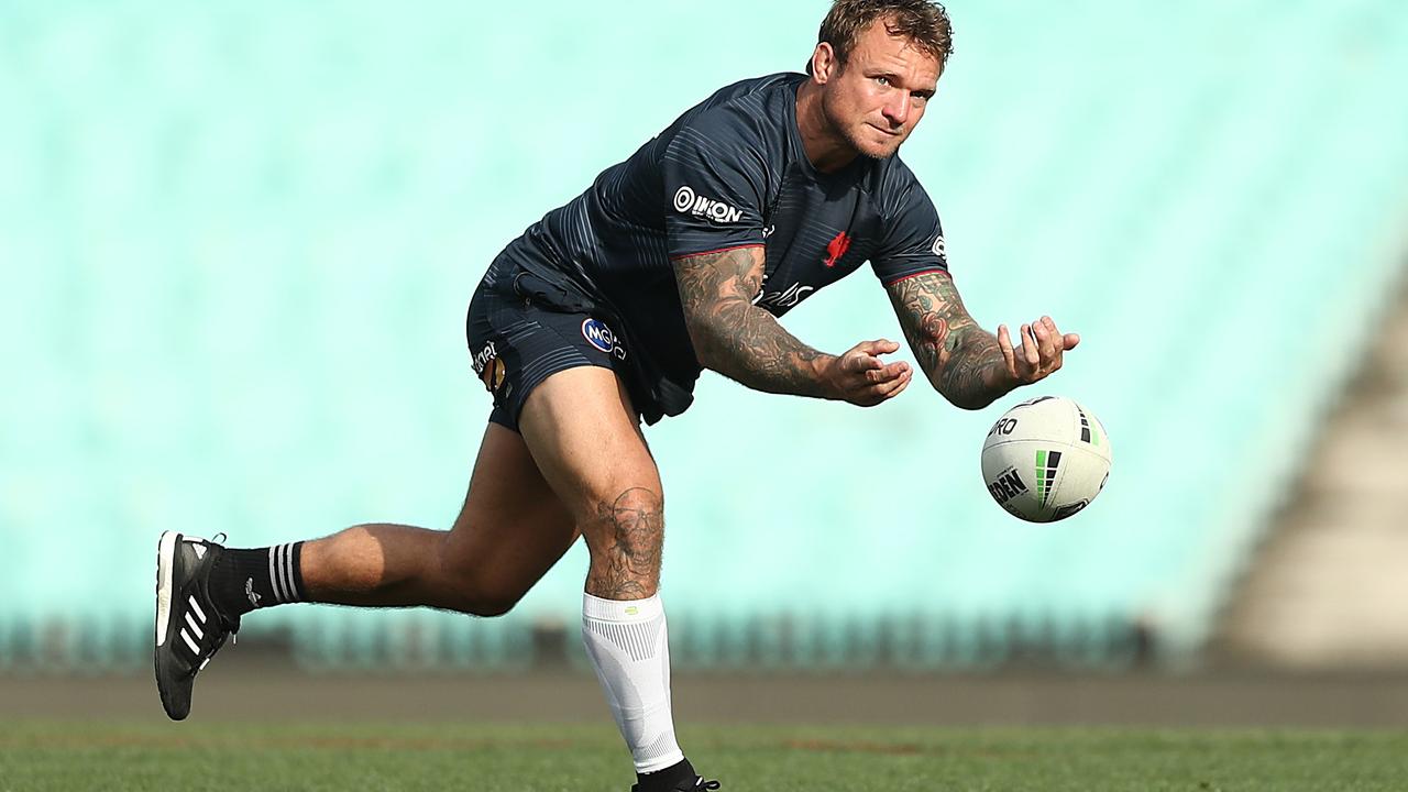 Jake Friend of the Roosters passes during a training session