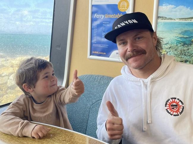 Caption: F1 driver Valtteri Bottas with Adelaide fan Lachie and cycling on Kangaroo Island