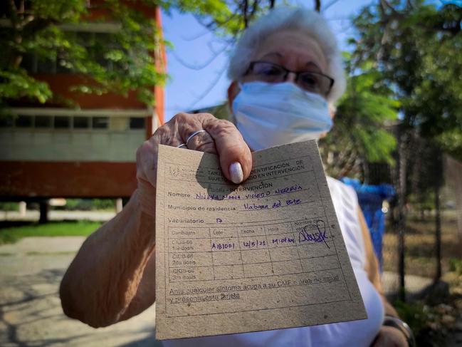 An elderly woman shows her vaccination card after receiving the first dose of Cuban vaccine candidate Abdala in Havana. Picture: AFP