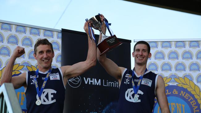 Kerang coach Troy Coates, left, and captain Josh Nitschke lift the Central Murray premiership cup. Coates is joining South Bendigo next year. Picture: Tracy Roberts