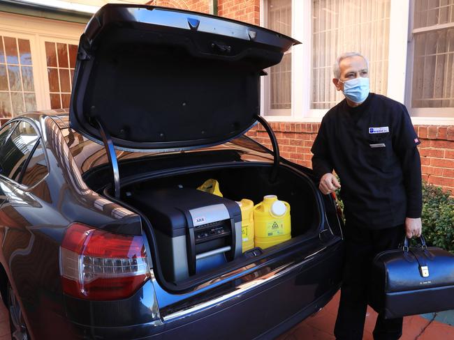 27/7/21: GP Dr Jamal Rifi loads his vaccine fridge into his car at his Belmore Medical Centre. He specifically bought the fridge so that he could deliver Pfizer vaccines to home-bound, at-risk patients in hotspot LGAs. John Feder/The Australian.