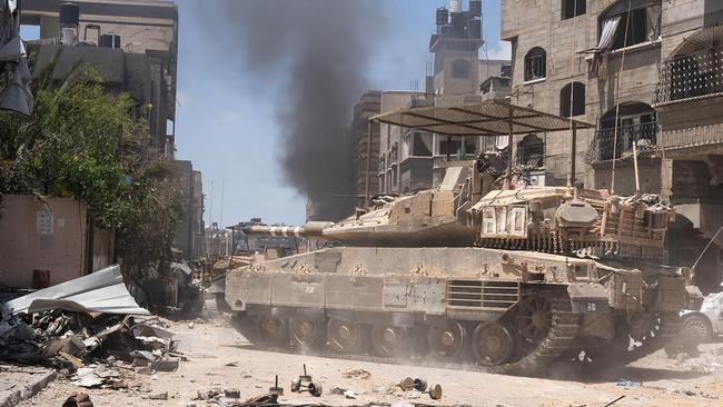 TOPSHOT - This handout picture released by the Israeli army on May 31, 2024 shows an Israeli army tank during operations in the Gaza Strip amid the ongoing conflict between Israel and the Palestinian militant group Hamas. (Photo by Israeli Army / AFP) / === RESTRICTED TO EDITORIAL USE - MANDATORY CREDIT "AFP PHOTO / Handout / Israeli Army' - NO MARKETING NO ADVERTISING CAMPAIGNS - DISTRIBUTED AS A SERVICE TO CLIENTS ==