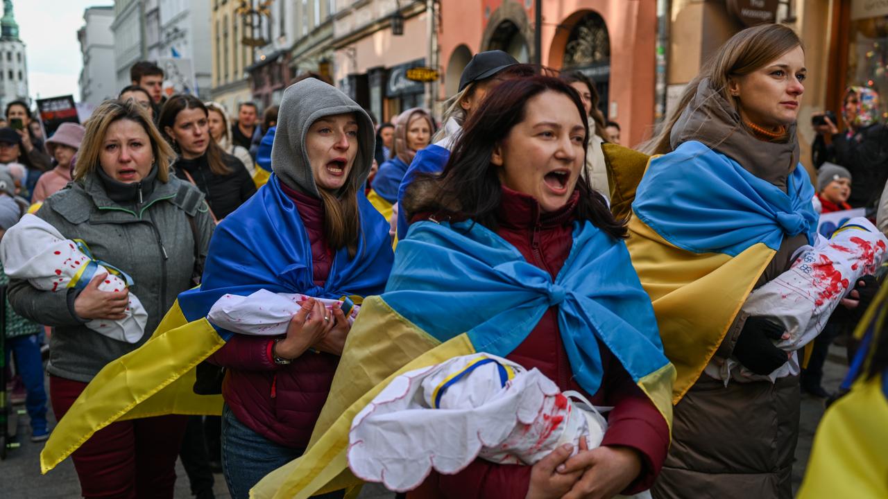 Ukrainian mothers in Poland carry handmade dolls resembling babies during a peaceful protest against the killing of children by the Russian army during the invasion of Ukraine. Picture: Omar Marques/Getty Images