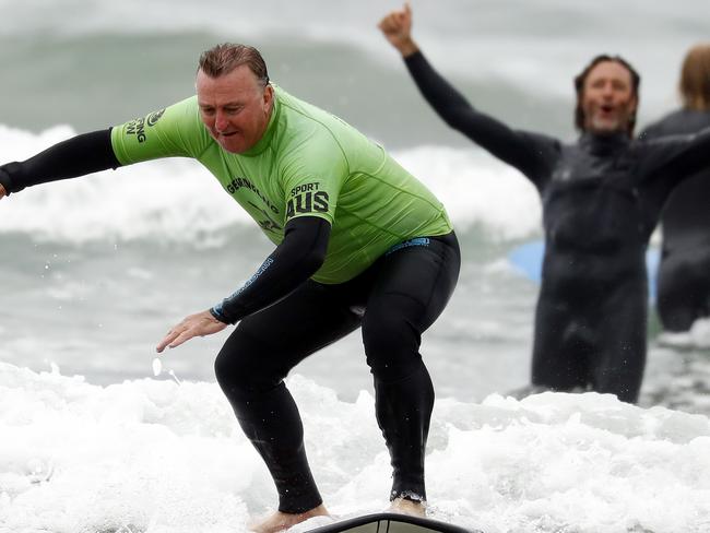 WEEKEND TELEGRAPH - 11.2.21*** MUST CHECK WITH WEEKEND PIC EDITOR ROHAN KELLY BEFORE PUBLISHING ***Ex service men and women take part in the "Veteran Surf Project" run by ex pro surfer Rusty Moran at Gerroa today. Rusty has started the project to hep veterans with PTSD.  Rusty cheers as a vet catches a wave.  Picture: Sam Ruttyn