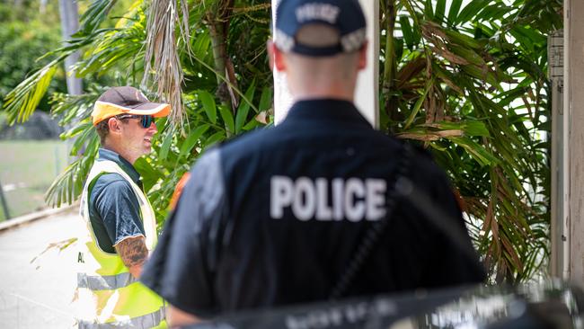 Seven people have been fined for breaching quarantine restrictions over the weekend, including one man who has been slapped with his third fine. Pictured are NT police and public health officers conducting a compliance check at a residence. Picture: Che Chorley