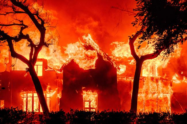 A home is engulfed by flames in Los Angeles County. Picture: AFP