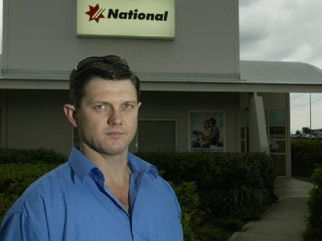 Senior Constable Neil Scutts stands outside the bank at Browns Plains where he was allegedly shot by a robber during a bank heist in 1999.