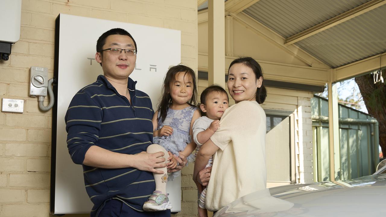 Lingwen Kong with his family, Olivia Kong, 3, Oscar Kong, 8 months, and Joy Kong at home in Fullarton, with their BYD Atto 3, solar and battery. Picture: Matt Loxton