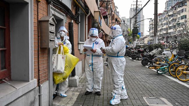 Medics work along a street in Jing'an district in Shanghai on March 26. Picture: Hector Retamal/AFP