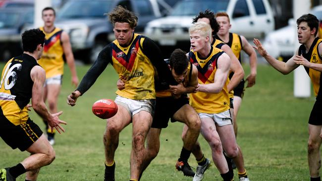 Brighton’s Jay Boyle gets a kick away despite the tackling efforts of Broadview’s James Iannucci on Saturday. The Bombers won by 43 points. Picture: AAP/Morgan Sette.