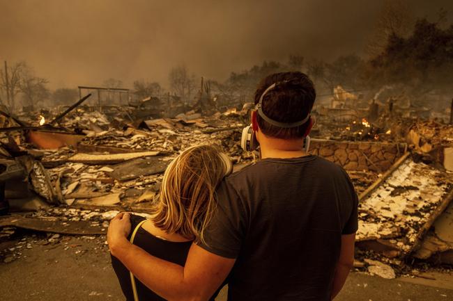 Megan Mantia and her boyfriend Thomas return to Mantia’s fire-damaged home after the Eaton fire. Picture: AP