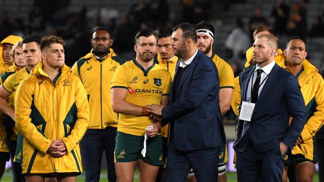 Wallabies coach Michael Cheika shakes hands with players following the Bledisloe Cup match between the All Blacks and the Wallabies at Eden Park in 2019.