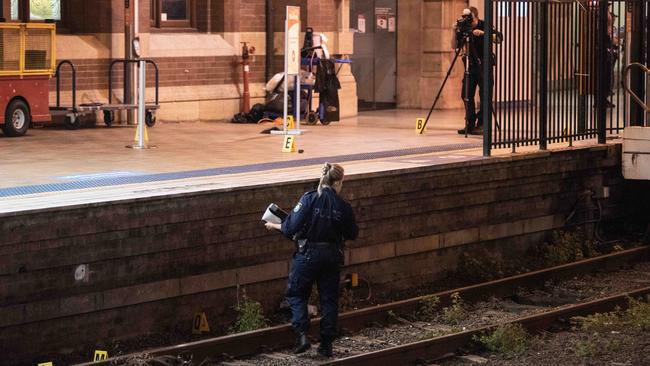 Police search and photograph the area as part of their investigation. Picture: Flavio Brancaleone