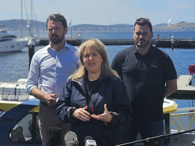 Liberal Senator Jonno Duniam, Environment Minister Madeleine Ogilvie and Salmon Tasmania CEO Luke Martin speak to the media on the Hobart waterfront on Thursday, January 9, 2025.