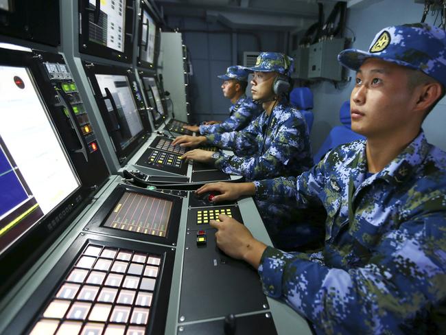 Chinese navy sailors search for targets on-board the missile destroyer Hefei during a military exercise in the waters near south China's Hainan Island and Paracel Islands. They are controlled by Beijing but also claimed by Vietnam and Taiwan. Picture: AP