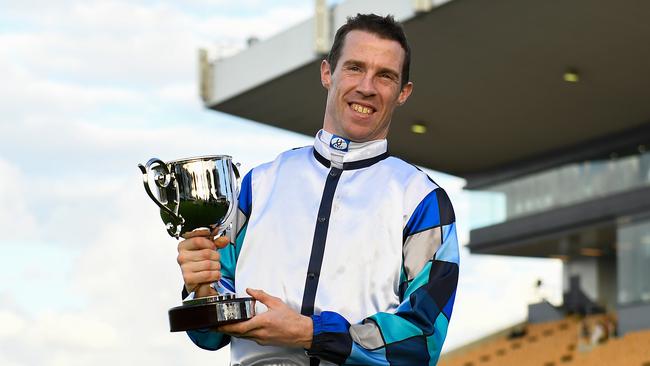 Jockey John Allen with the Doomben Cup trophy after riding Kenedna to victory.