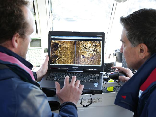 Hydrographic Surveyors Scott Kenny and Dominic Marino evaluating the huge quantity of material on the floor of Pittwater, off Scotland Island. Photo Manly Daily