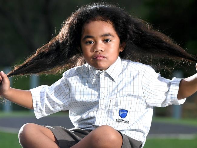 Wendy Taniela with her 5 year old son Cyrus Taniela in a play ground in Upper Caboolture.The mother of a five-year-old boy with long hair says his Caboolture school, Australian Christian College Moreton, told them it had to be cut despite his hair cutting ceremony, which is part of his father’s Cook Islands and Niuean heritage, being still a year awayMonday February 10,2020. (AAP image, John Gass)