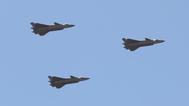 Chinese J-20 stealth fighter jets fly past during the parade. Picture: AFP