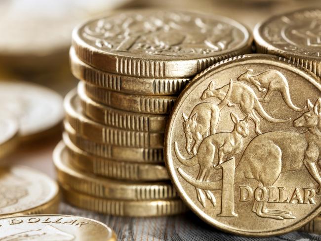 Stacks of Australian one dollar coins.  Focus on front coin. Australian cash, money generic