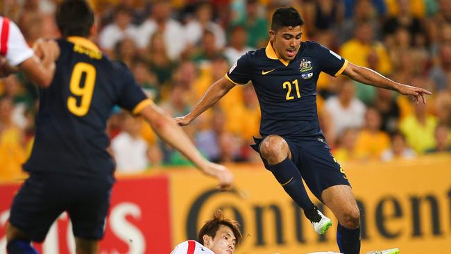 Massimo Luongo of Australia fights for the ball with Han Kook Young of South Korea.