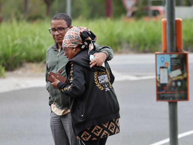 A couple in grief at the bus stop. Picture: David Crosling