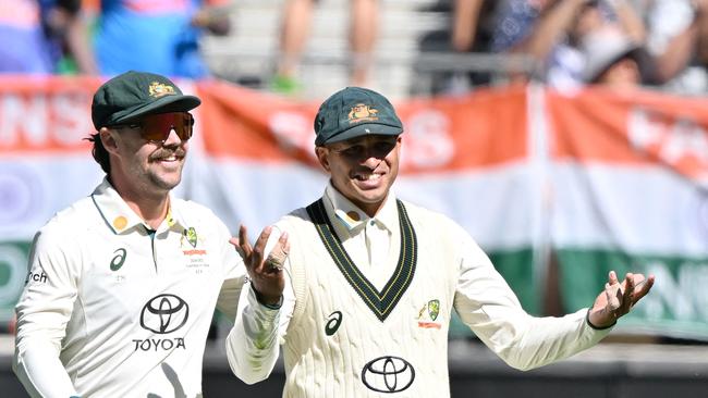 Usman Khawaja and Travis Head celebrate a wicket in the first Test against India.