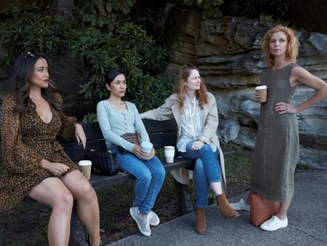 The cast on the same bench during a break in filming.