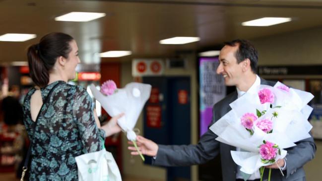 Dave Sharma hands out flowers.