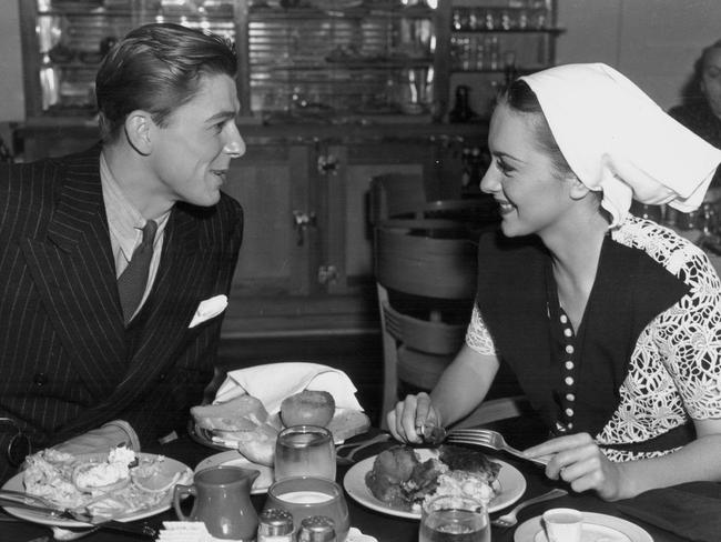 Ronald Reagan and Olivia de Havilland have lunch in Los Angeles in 1938.