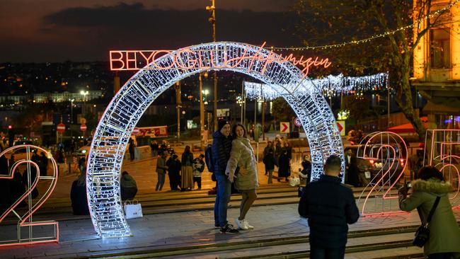 People pose in front of a 2025 sign, on the eve of the New Year, at Sishane Square in Istanbul on December 31, 2024. Picture: AFP